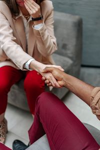 Two professionals shaking hands indoors, symbolizing agreement and collaboration.